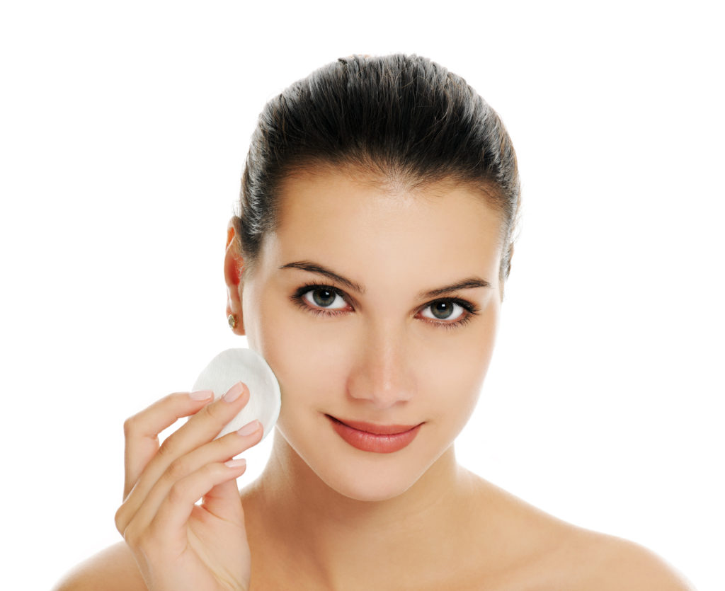 cheerful woman cleaning her face